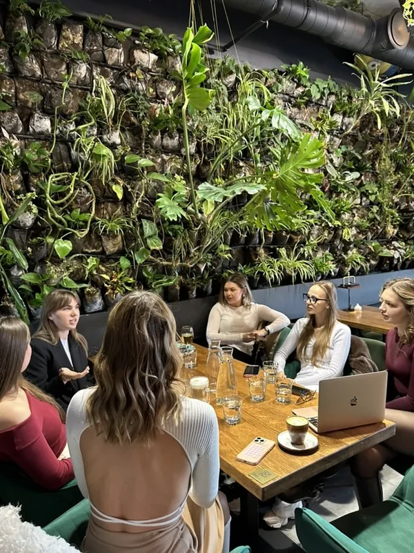 a women who speak meeting in a green café in warsaw